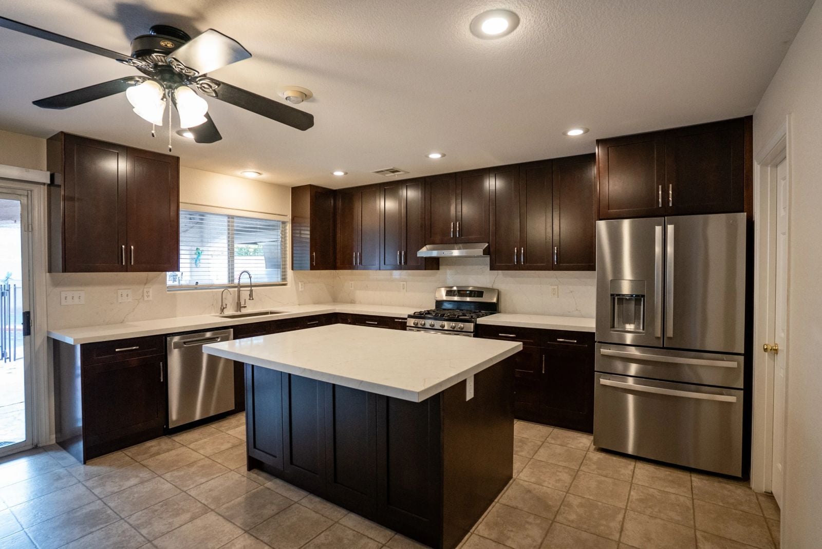 Kitchen after remodel with espresso cabinets and quartz island Las Vegas