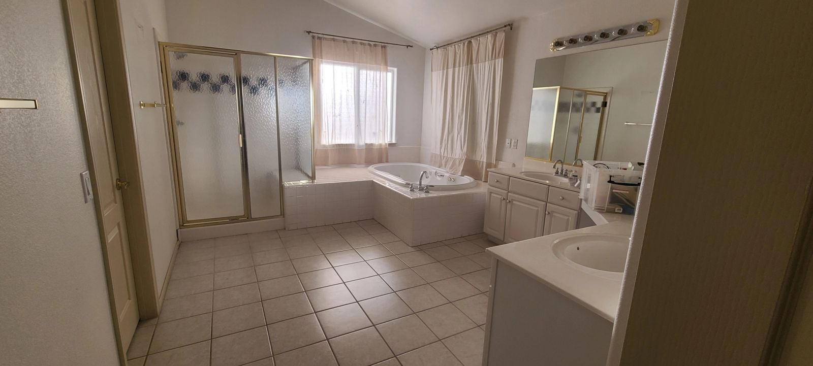 Master bathroom before remodel with corner tub Las Vegas