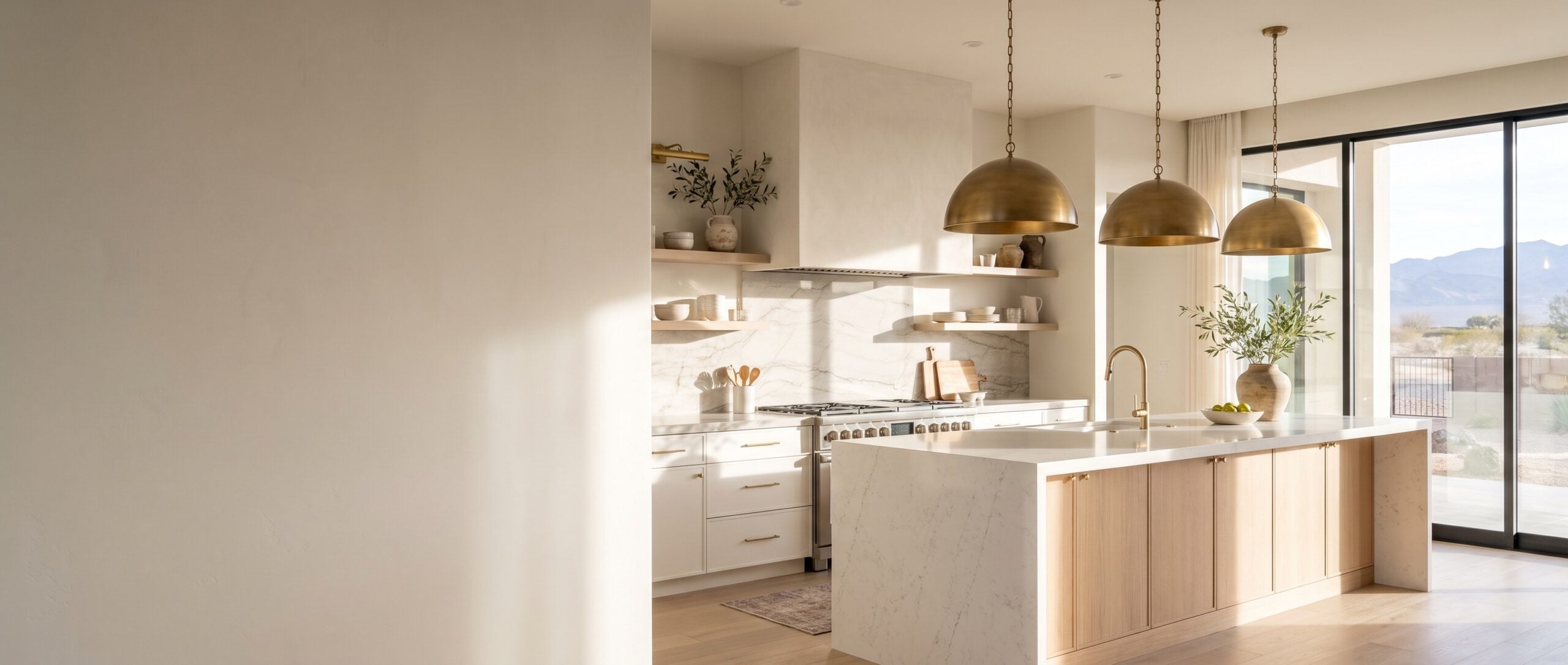 Custom kitchen remodeling in a Las Vegas home with white oak island, quartz counters and brass pendants