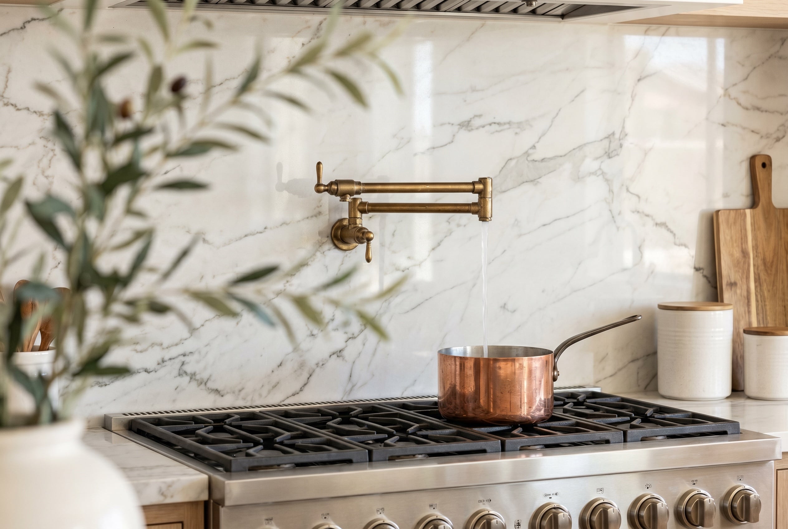 Marble slab backsplash and quartz counter with brass pot filler in a Las Vegas kitchen