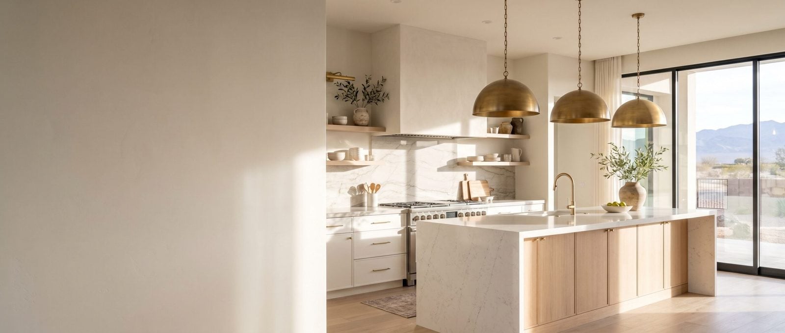 Custom kitchen remodeling in a Las Vegas home with white oak island, quartz counters and brass pendants